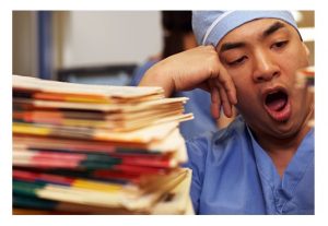 getty_rm_photo_of_nurse_yawning_over_paperwork